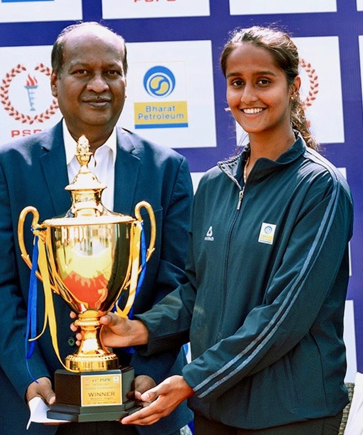 Women’s champion Vaishnavi Adkar receives the trophy after winning the PSPB inter-unit tennis tournament in Pune on Saturday.