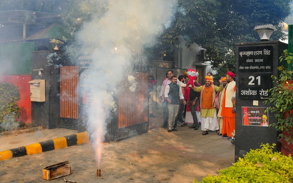 Supporters celebrate at BJP MP Brij Bhushan Sharan Singh’s residence after Sanjay Singh became the new president of the Wrestling Federation of India.