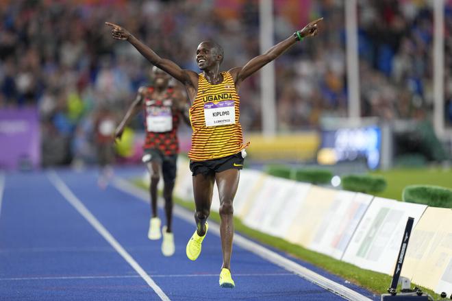 Jacob Kiplimo of Uganda celebrates as he approaches the finish line to win the gold medal in the men’s 10,000m final on Tuesday. 