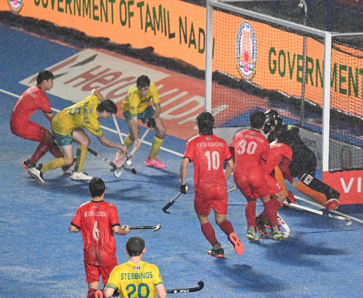 Daykin Stanger (left, yellow jersey-5) of Australia scoring a goal against Korea during a Men's Junior Hockey World Cup 2025 match. 