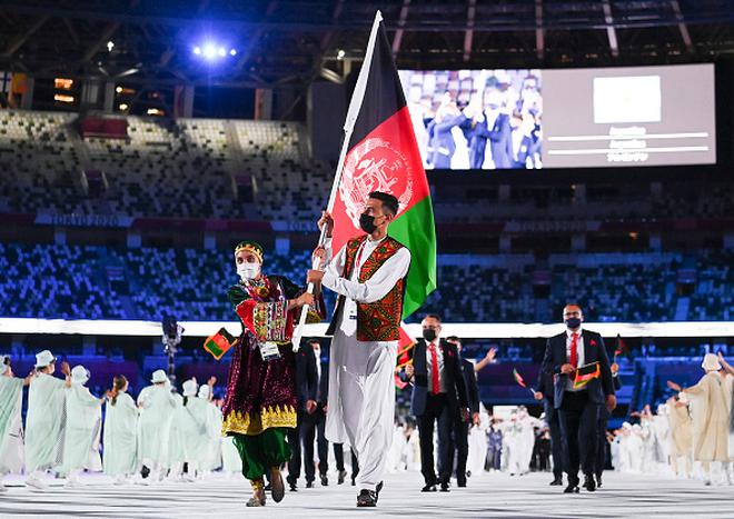 FILE PHOTO: Afghanistan flag bearers Kimia Yousofi and Farzad Mansouri lead their team during the Opening Ceremony of the Tokyo 2020 Olympic Games at Olympic Stadium on July 23, 2021 in Tokyo, Japan. 