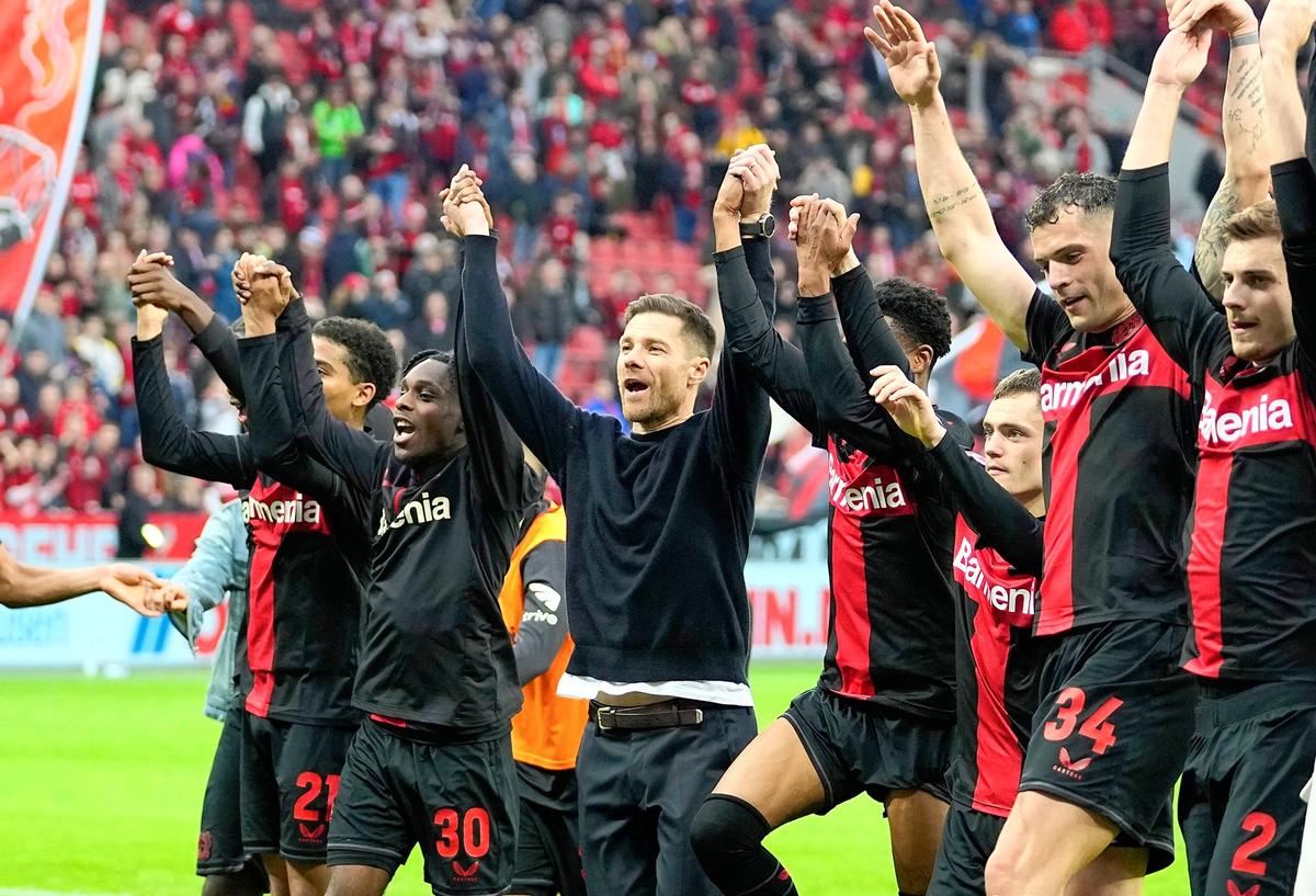 The perfect underdog story: Leverkusen’s head coach Xabi Alonso, centre, celebrates with his team after winning the German Bundesliga title.