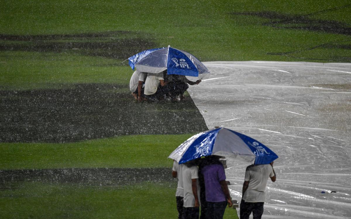 Ground in a pool of water as heavy rain delays the start.