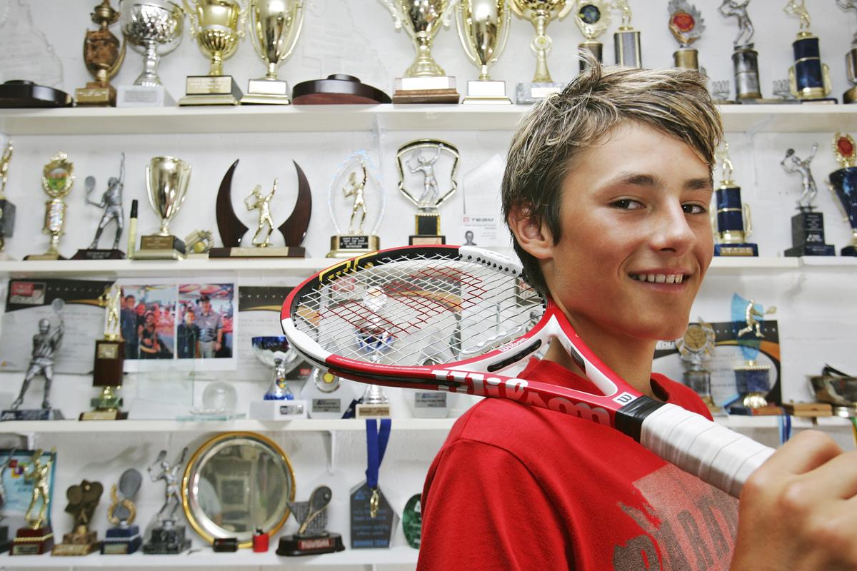 File photo: Junior tennis player, Bernard Tomic of Australia poses at home with his trophies on April 19, 2006 on the Gold Coast, Australia.   