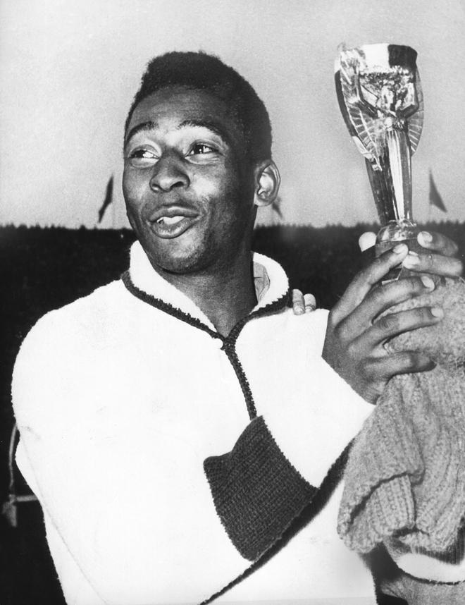 Pele holds up the Jules Rimet Trophy after Brazil won the 1962 World Cup in Chile.