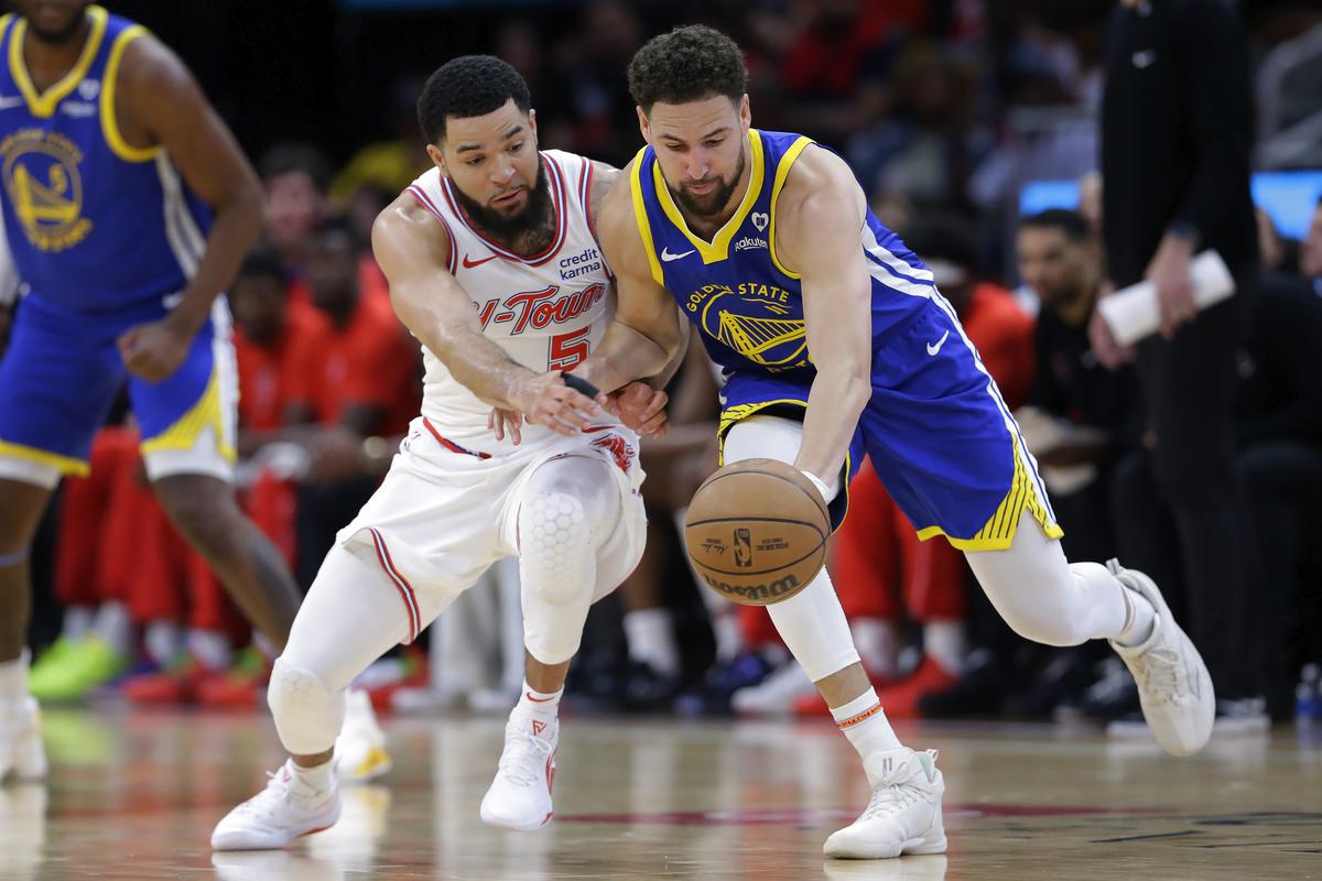 Houston Rockets guard Fred VanVleet, left, chases the ball he knocked away from Golden State Warriors guard Klay Thompson, right, during the first half of an NBA basketball game.