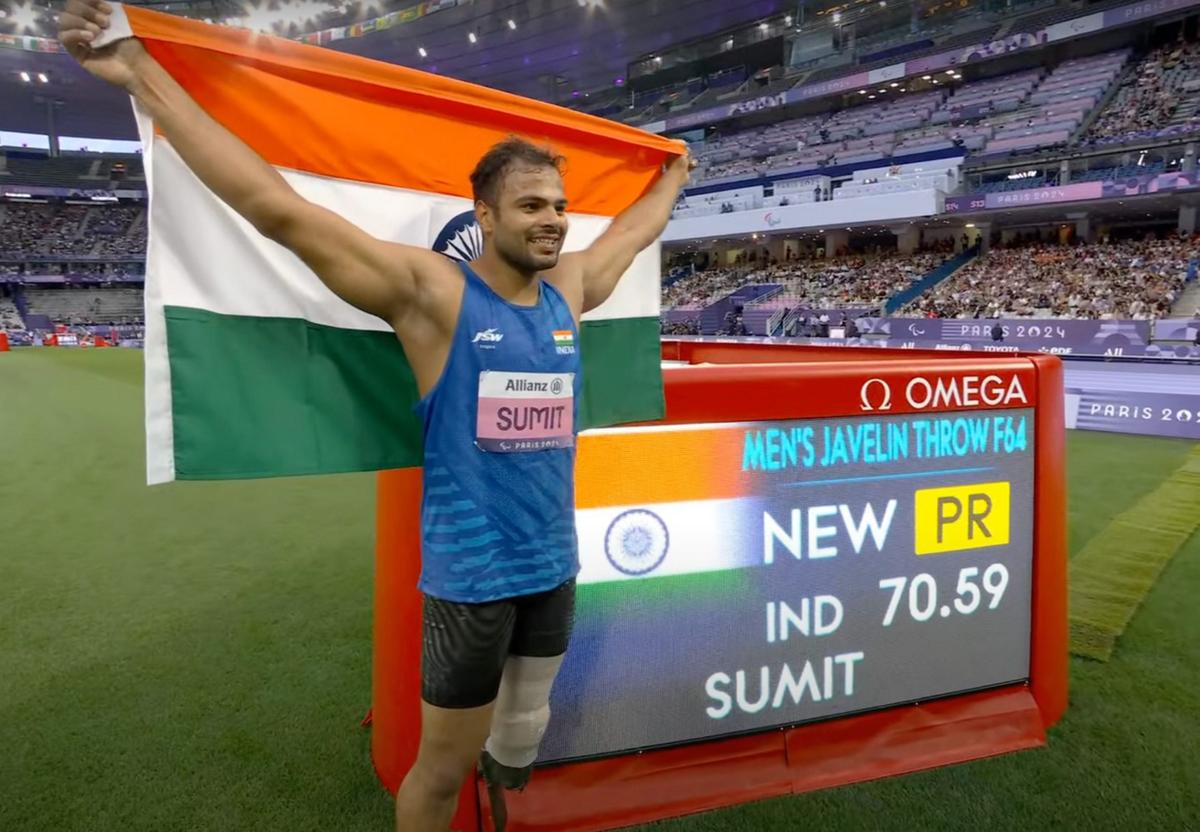 Sumit Antil poses for photographs after winning the gold medal in javelin throw F64 event in Paralympics 2024.