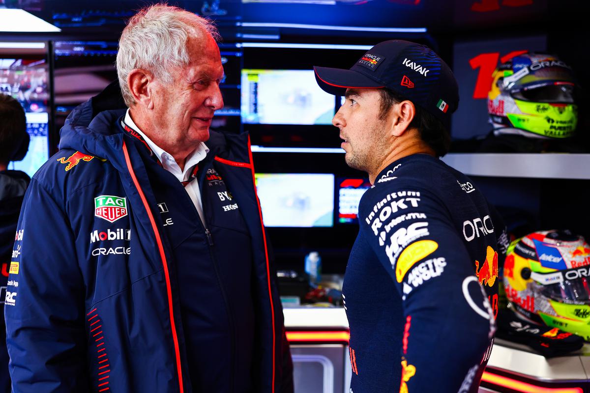 FILE PHOTO: Sergio Perez of Mexico and Oracle Red Bull Racing talks with Red Bull Racing Team Consultant Dr Helmut Marko in the garage during qualifying ahead of the F1 Grand Prix of The Netherlands at Circuit Zandvoort.