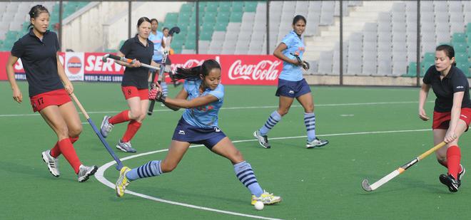 India’s Sushila Chanu on her way to score a goal against Azerbaijan during the Women’s Hockey Test Match at Dhyan Chand Stadium in New Delhi on January 18, 2012.