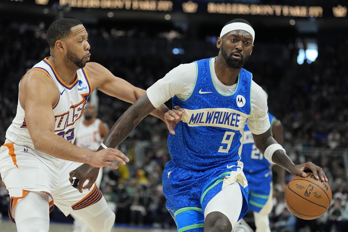 Milwaukee Bucks’ Bobby Portis tries to get past Phoenix Suns’ Eric Gordon during the second half of an NBA basketball game.