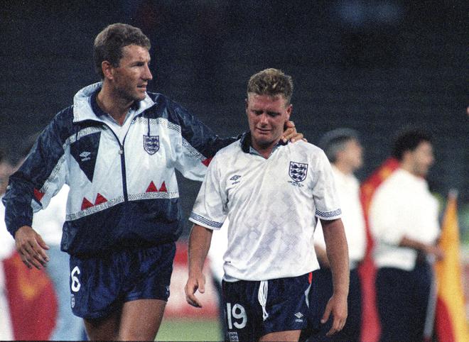 FILE PHOTO: England's Paul Gascoigne (right) cries as he is escorted off the pitch by team captain Terry Butcher (left) after England lost to West Germany on penalties in the semi-final of the FIFA World Cup FIFA in Turin, Italy, on July 4.  , 1990. 