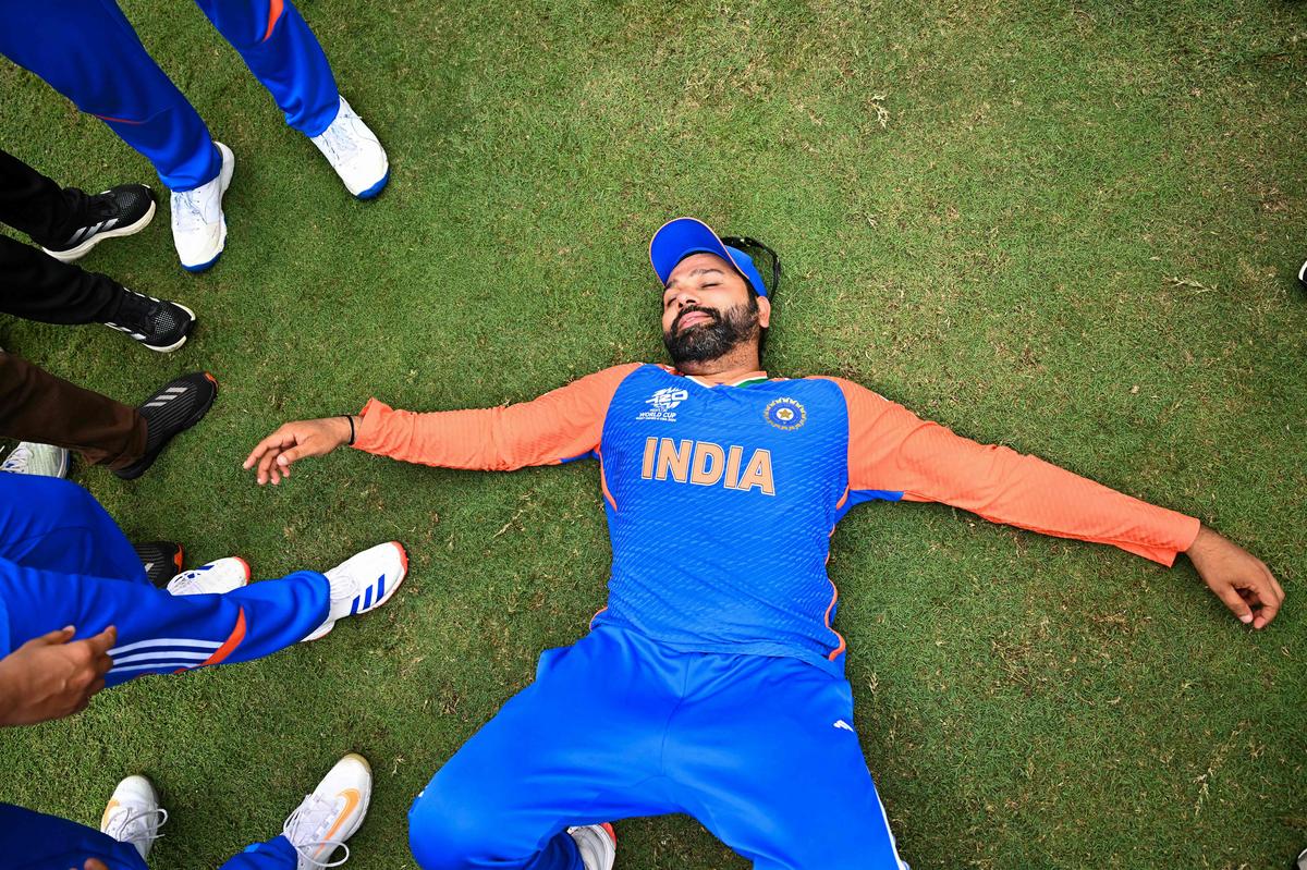 India’s captain Rohit Sharma lies on the ground as he celebrates with Team India after winning the ICC men’s Twenty20 World Cup 2024. 