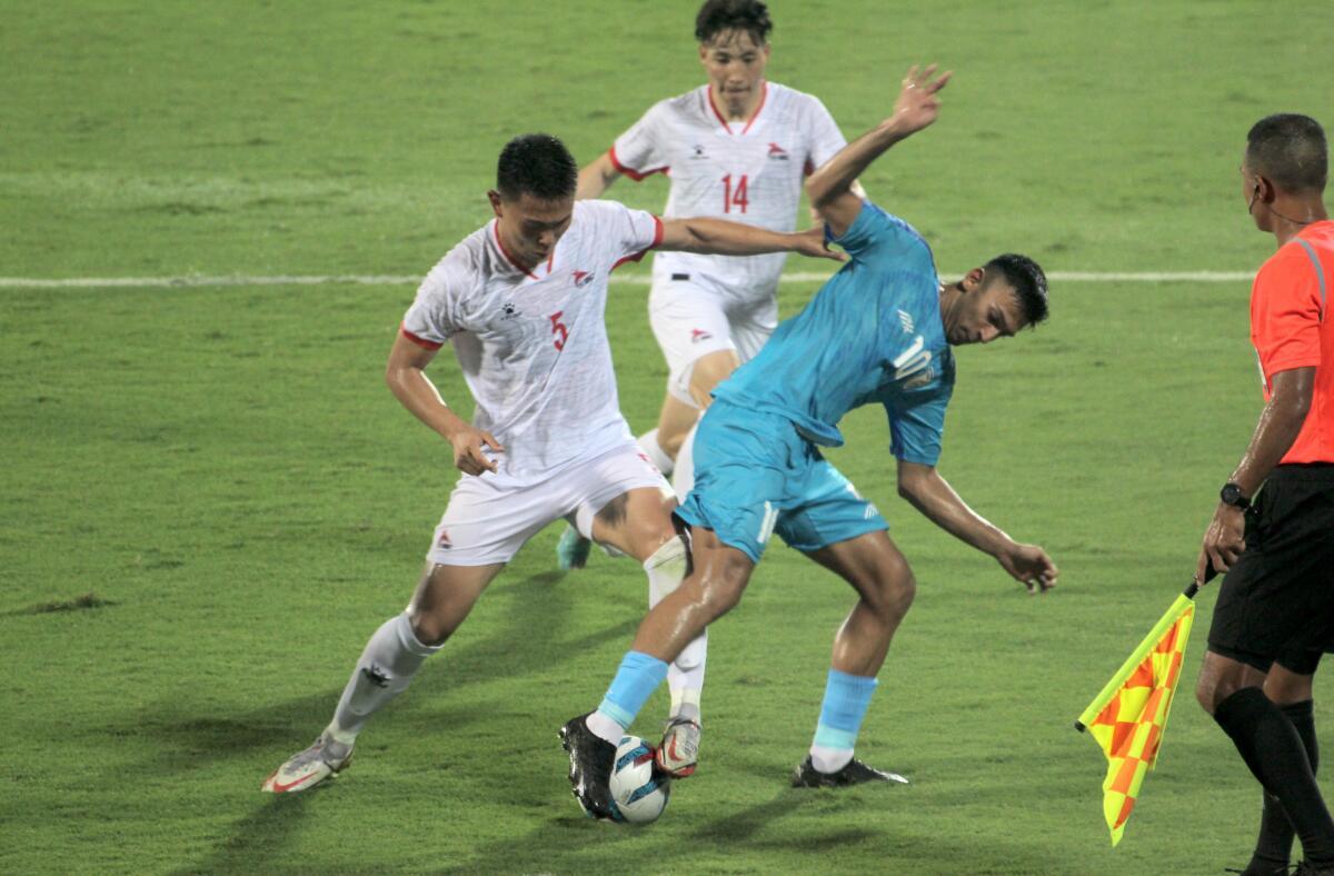 Indian winger Lallianzuala Chhangte tussles with Mongolian players to take control of the ball during the Intercontinental Cup match at the Kalinga Stadium in Bhubaneswar on June 9, 2023.