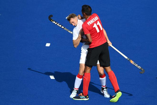 Christopher Griffiths England (left) and Balraj Panesar of Canada are involved in an altercation during Men’s Hockey Pool B match on Thursday. 