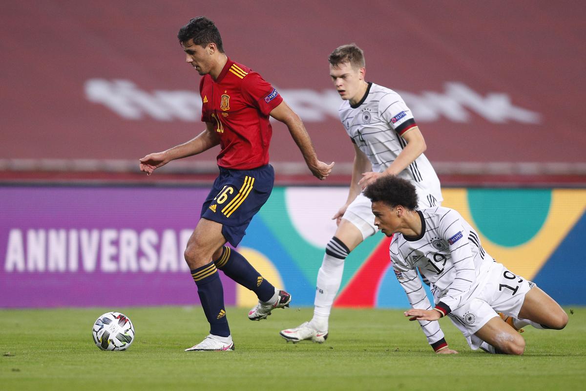 Rodri of Spain eludes Matthias Ginter and Leroy Sane of Germany during the UEFA Nations League group stage match between Spain and Germany at Estadio de La Cartuja on November 17, 2020 in Seville, Spain.