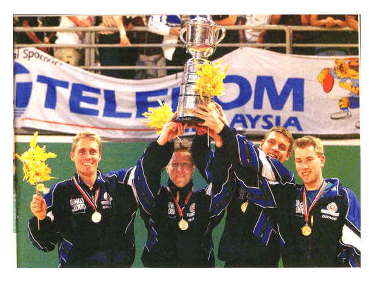 Jorgen Persson, Jan-Ove Waldner, Peter Karlsson and Fredrik Hakansson hold aloft the World Championships trophy.