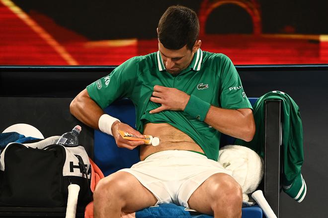 [FILE] Novak Djokovic of Serbia rubs cream into his side in his Men’s Singles third round match against Taylor Fritz of the United Statesduring day five of the 2021 Australian Open 