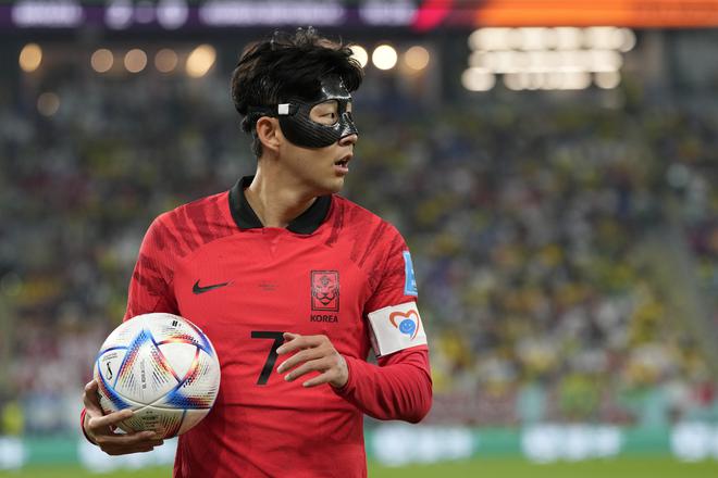 South Korea’s Son Heung-min, wearing a mask, walks with the ball during the FIFA World Cup Round of 16 match against Brazil at the Stadium 974 in Al Rayyan, Qatar on Dec. 5, 2022.