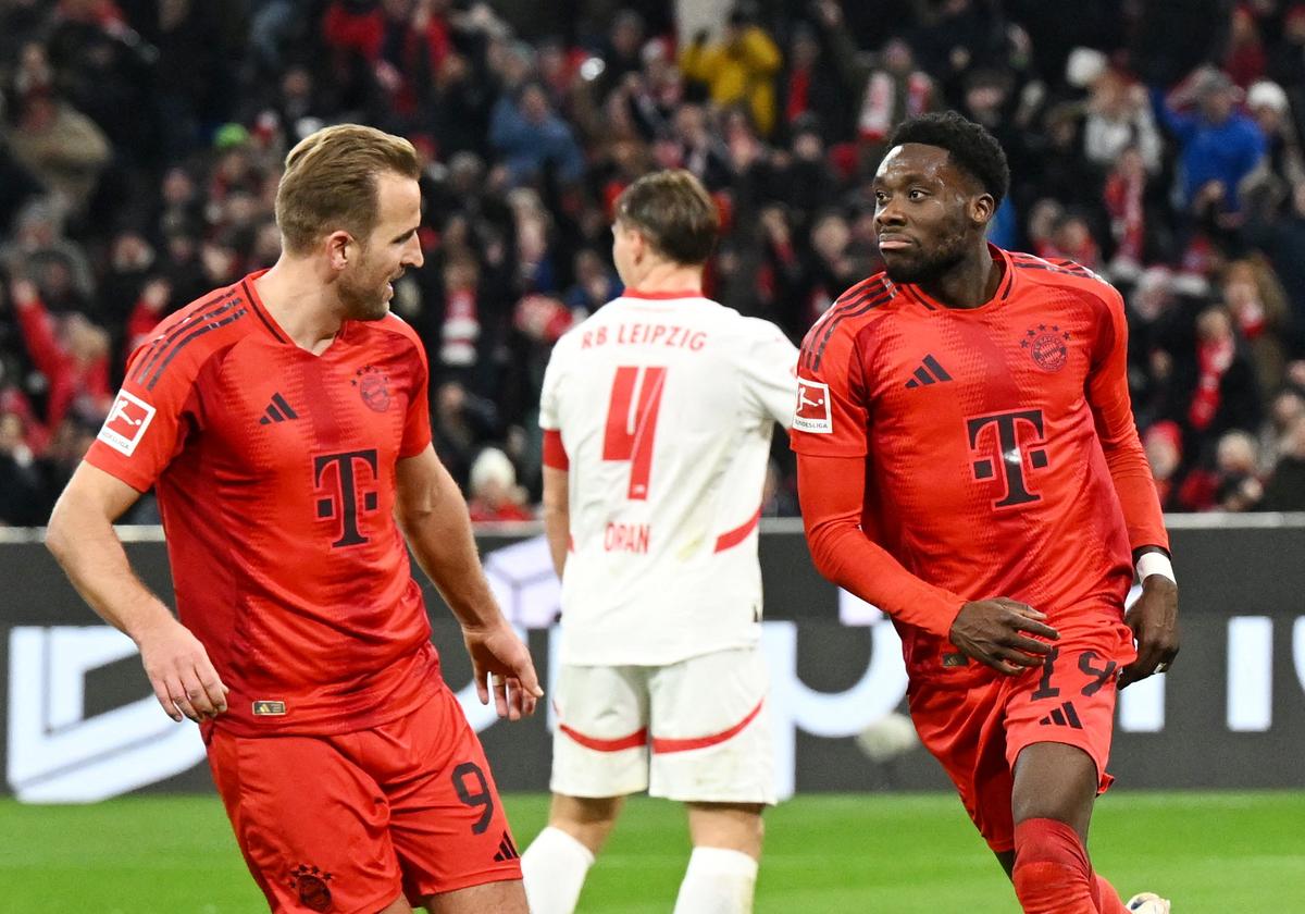 Harry Kane (left) celebrates with Alphonso Davies (right), after scoring a goal for Bayern Munich against RB Leipzig in German Bundesliga.