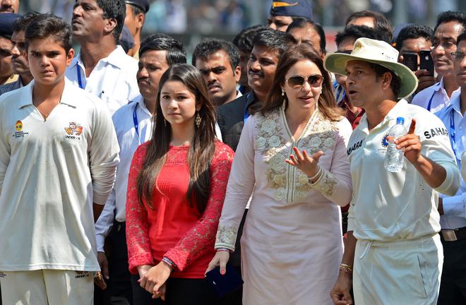 A career to cherish: Sachin, in the company of his family, is emotional after playing his last and 200th Test match, against the West Indies at the Wankhede Stadium in Mumbai on November 16, 2013. 