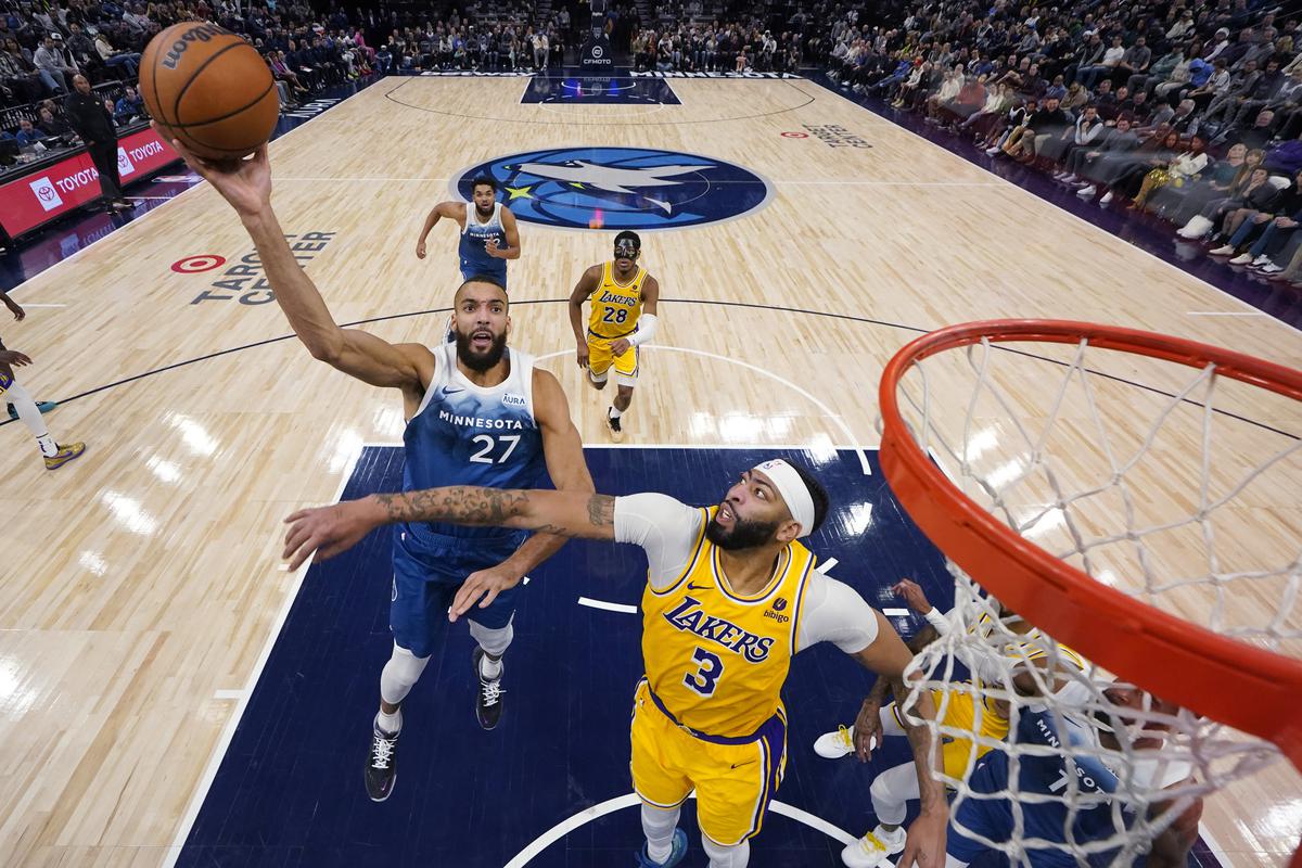 Minnesota Timberwolves center Rudy Gobert (27) shoots as Los Angeles Lakers forward Anthony Davis (3) defends during the second half of an NBA basketball game Thursday.