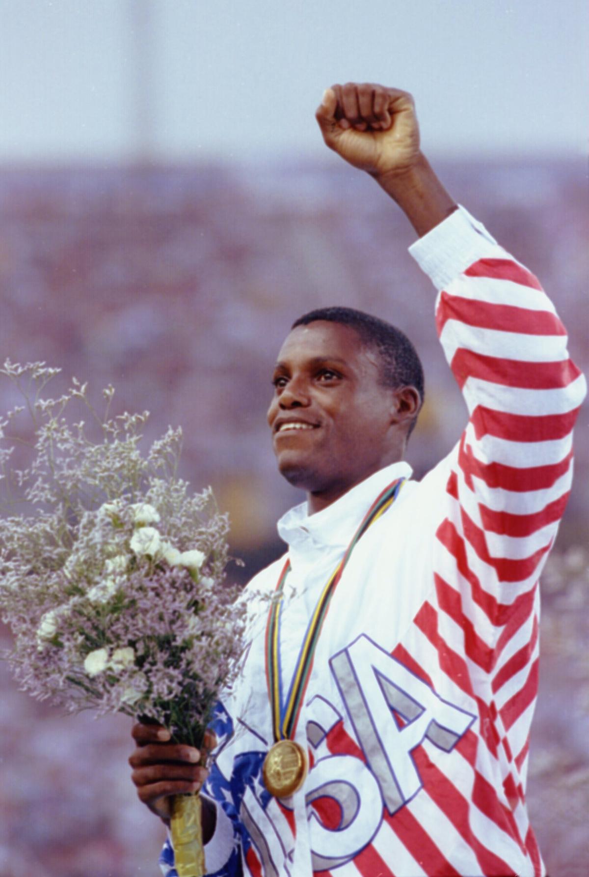 Carl Lewis of the USA celebrates after receiving the gold medal in the long jump at the 1992 Summer Olympics.