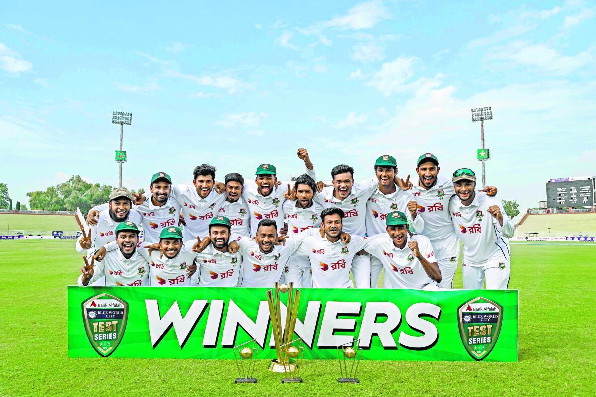 Bangladesh‘s players celebrate with the trophy after winning the second and last Test match against Pakistan in Rawalpindi. 