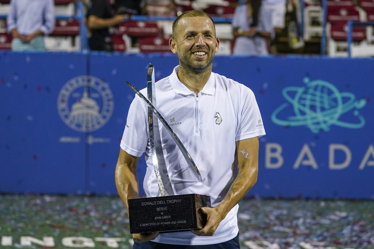 Daniel Evans, of Britain, holds the trophy after defeating Tallon Griekspoor, of the Netherlands, in the men's singles final of the DC Open tennis tournament Sunday, Aug. 6, 2023, in Washington. (AP Photo/Alex Brandon)