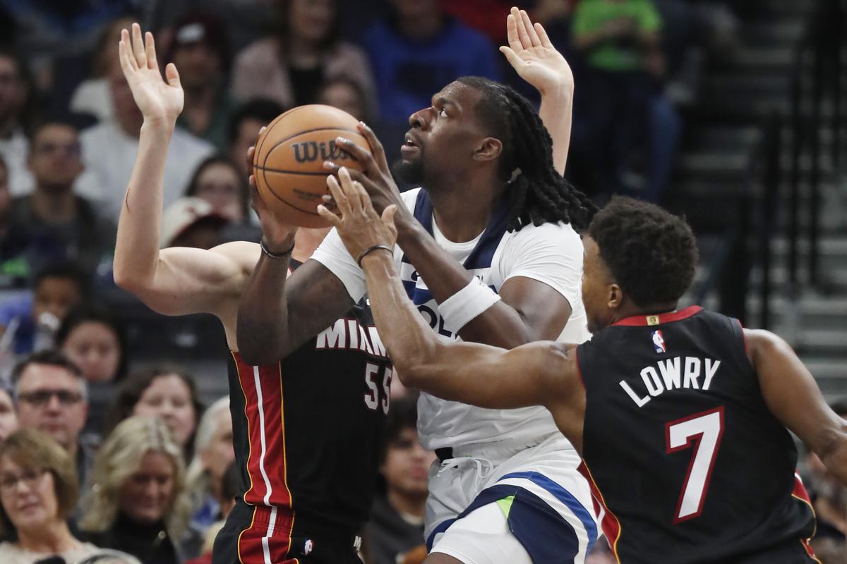 Minnesota Timberwolves’ Naz Reid, center, drives to the basket between Miami Heat guards Duncan Robinson (55) and Kyle Lowry (7) in the third quarter of the game.