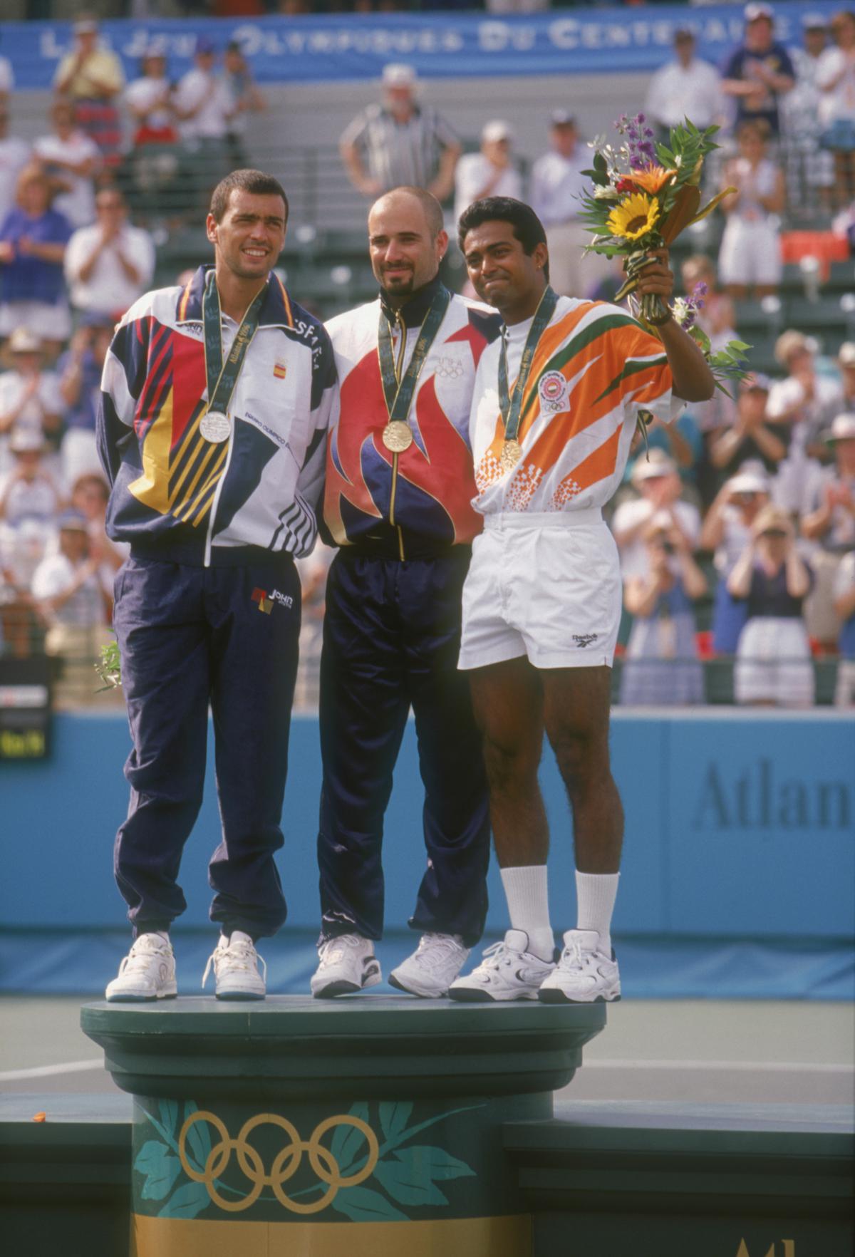  (L-R) Sergi Bruguera of Spain wins silver, Andre Agassi of the USA wins gold and Leander Paes of India wins bronze in the men’s singles tennis event at the 1996 Summer Olympic Games in Atlanta, Georgia on August 3, 1996.