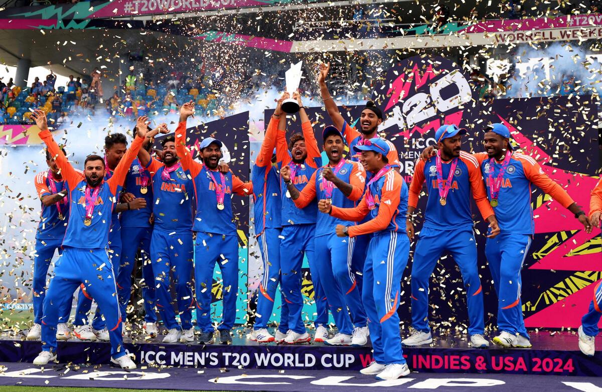 India‘s Kuldeep Yadav lifts the T20 World Cup trophy. 