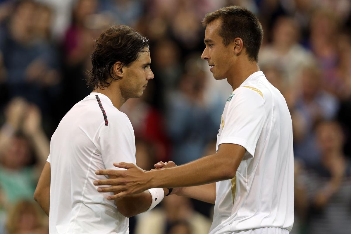 File | Lukas Rosol of the Czech Republic shakes hands with  Rafael Nadal of Spain after defeating him during their Gentlemen’s Singles second round match on day four of the Wimbledon Lawn Tennis Championships at the All England Lawn Tennis and Croquet Club on June 28, 2012 in London, England