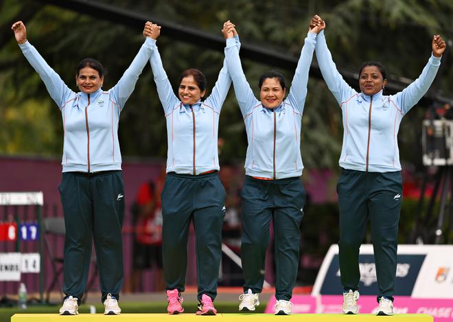 Lovely Choubey, Pinki, Nayanmoni Saikia and Rupa Rani Tirkey of India celebrate after winning the gold in the Women’s Fours Lawn Bowls event. 