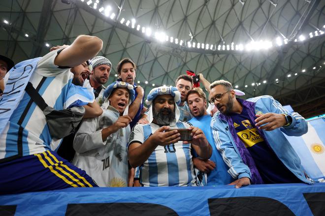 Curious neighbours: Argentina fans watch the penalty shootout of Croatia and Brazil. 