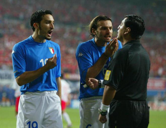 Gianluca Zambrotta (left) and Cristiano Zanetti (right) of Italy protest to referee Byron Moreno of Ecuador after he awarded a penalty to South Korea during the FIFA World Cup second Round match played at the Daejeon World Cup Stadium, in Daejeon, South Korea on June 18, 2002. 