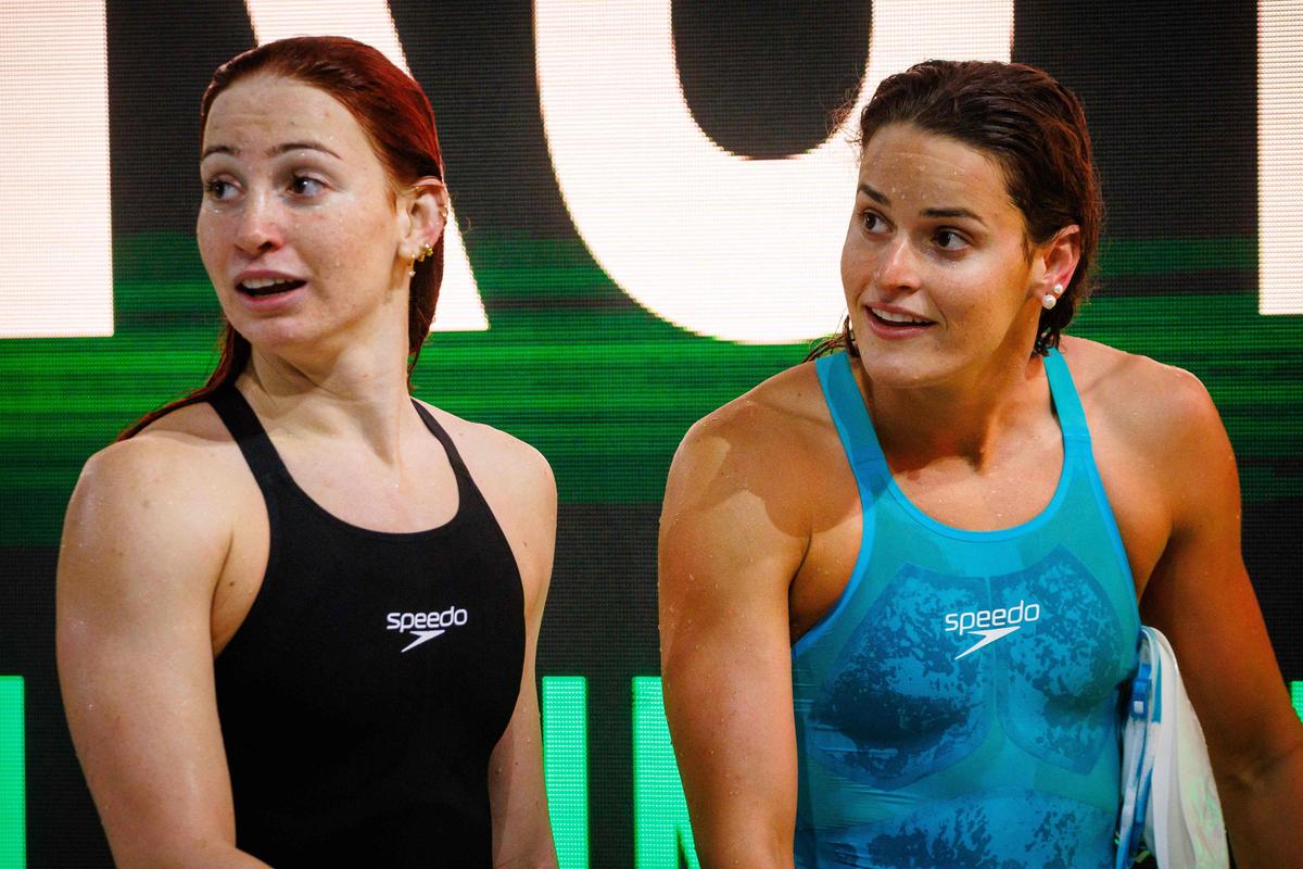 Australia’s Kaylee McKeown (R) and Mollie O’Callaghan (L) after the women’s 100m backstroke final during the Australian Swimming Trials. 