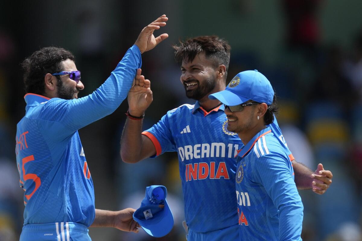 India’s captain Rohit Sharma, left, congratulates bowler Mukesh KumarÂ for dismissing West Indies’ Alick Athanaze during their first ODI cricket match at Kensington Oval. 