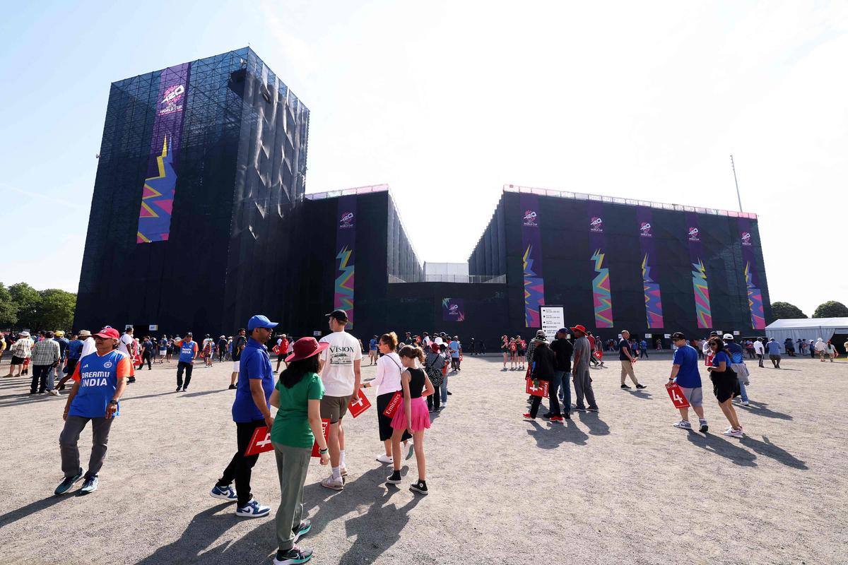 Spectators make their way towards the stadium ahead of a cricket match at the Nassau County International Cricket Stadium.