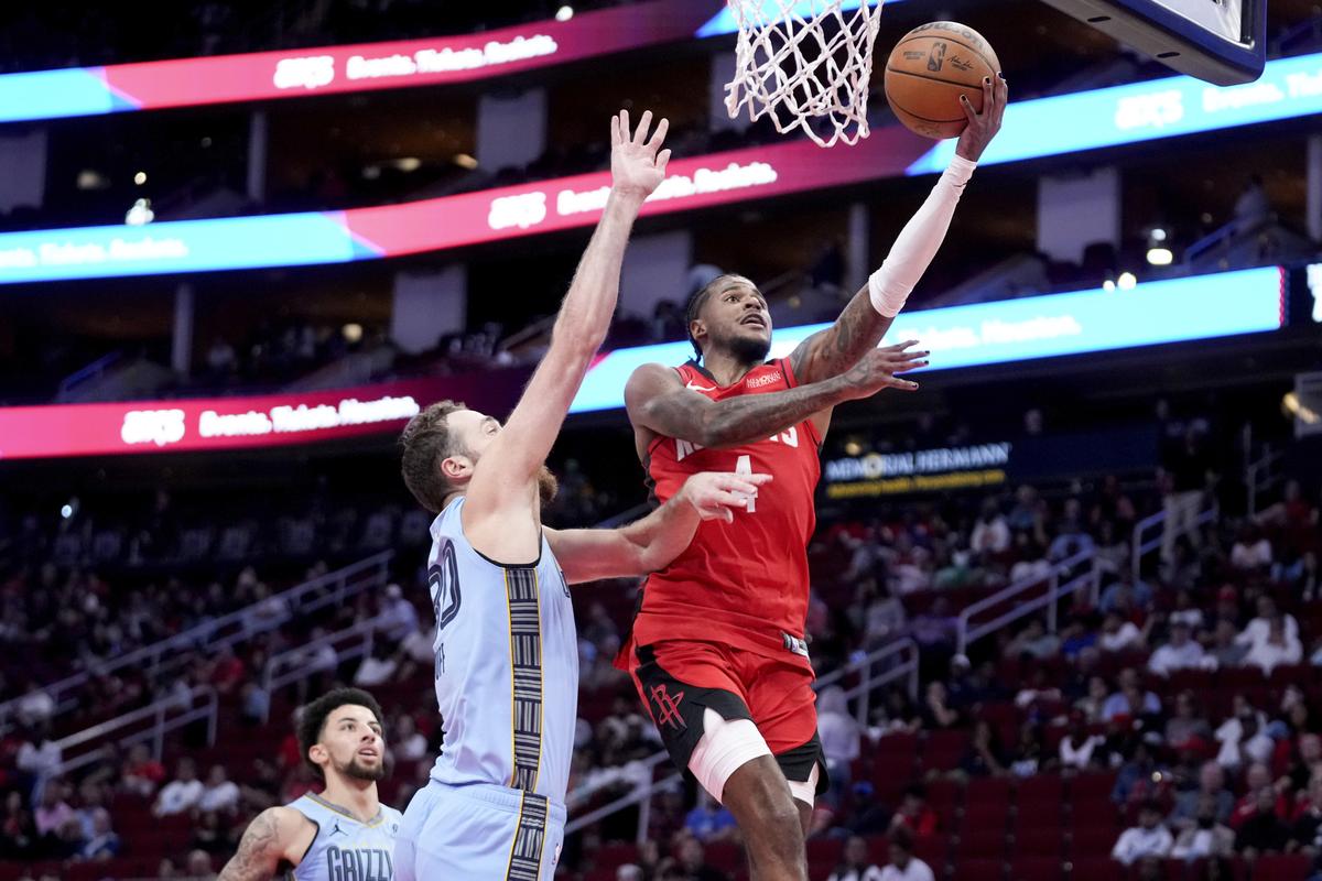 Houston Rockets guard Jalen Green, right, drives to the basket as Memphis Grizzlies centre Jay Huff defends.