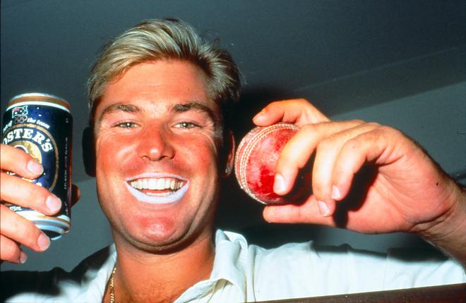 Living life king-size: Shane Warne celebrates with a can of beer in one hand a cricket ball in the other, after winning a test match with Australia.