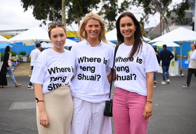 Spectators wearing 'Where is Peng Shuai?' t-shirts pose outside Melbourne Park ahead of the women's singles final.