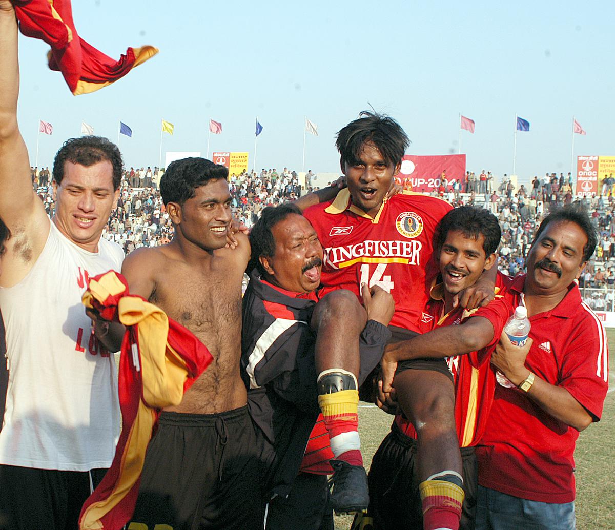 Chandan Das, the captain of the East Bengal team being lifted up by his team-mates,  to congratulate him after East Bengal won the the final match of the Durand Cup football title at the Ambedkar stadium in New Delhi on November 10, 2004. 
