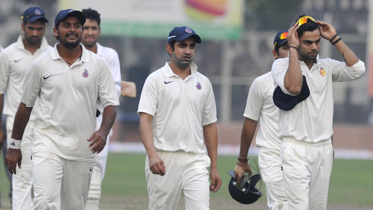 Delhi’s Sumit Narwal, Gautam Gambhir and Virat Kohli during the Ranji match against UP. 