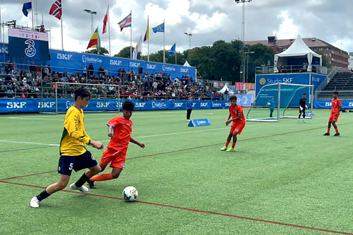 Minerva Academy’s players (in orange) in action against Ordin FC in the Gothia Cup final.