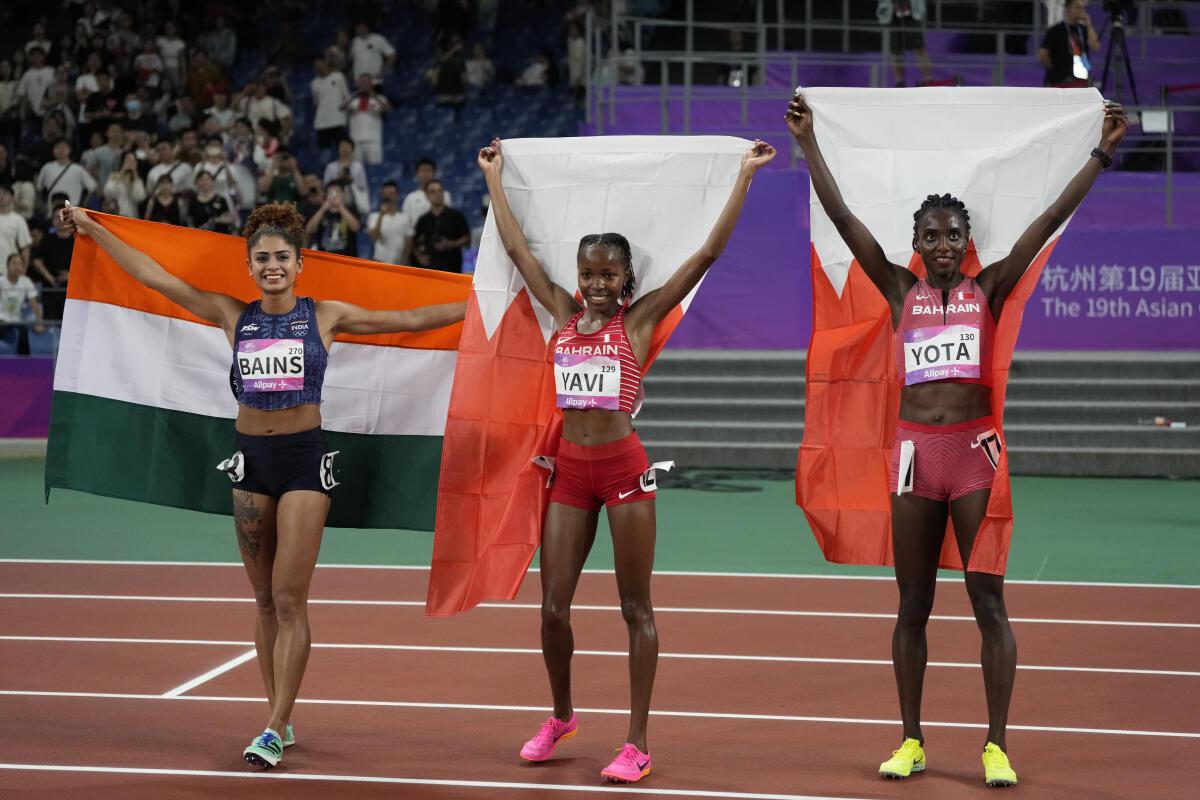 Medalists, from left, India’s Harmilan Bains, silver, Bahrain’s Winfred Mutile Yavi, gold, and and Bahrain’s marta Hirpato Yota, celebrate after their women’s 1500-meter final at the 19th Asian Games in Hangzhou, China, Sunday, Oct. 1, 2023