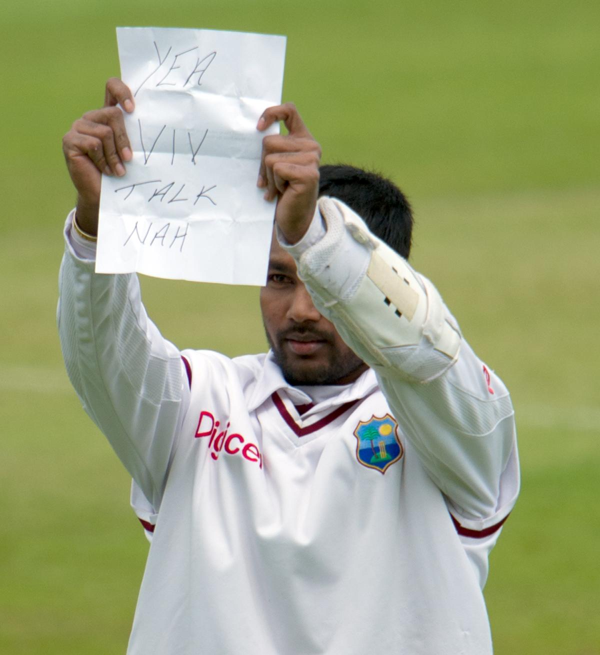 West Indies’ Denesh Ramdin holds a note for Sir Vivian Richards that said, “Yea Viv, Talk Nah” after reaching his 100 during the 4th day of the third Test match against England at Edgbaston.