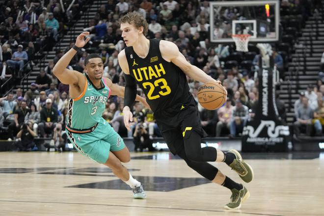 Utah Jazz forward Lauri Markkanen (23) drives as San Antonio Spurs forward Keldon Johnson (3) defends during the second half of an NBA basketball game Saturday, Feb. 25, 2023, in Salt Lake City. 