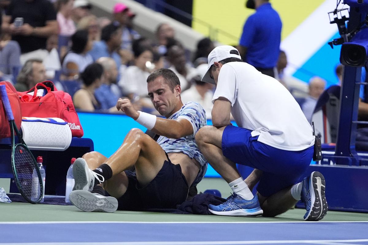 Serbia’s Laslo Djere is examined during a second-round match against Novak Djokovic. 