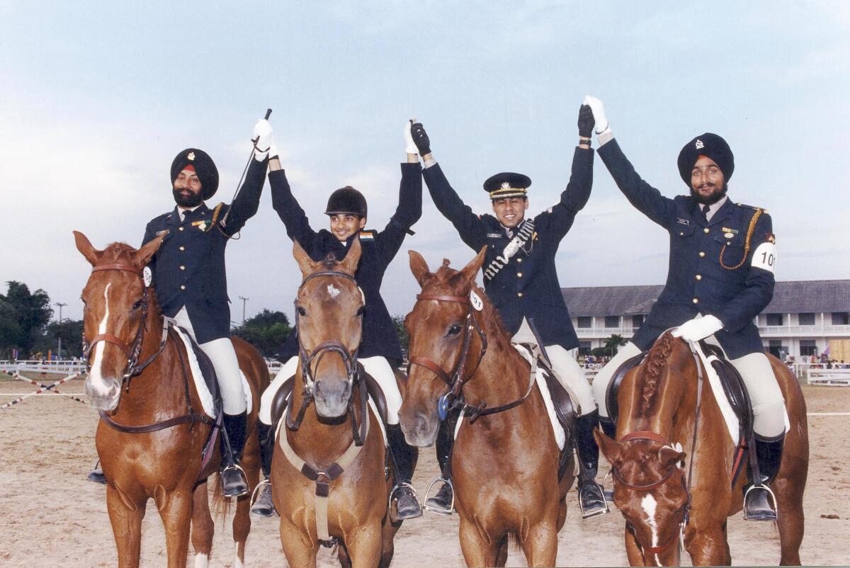 Amolakjit Singh, Imtiaz Anees, Rajesh Pattu and Palwinder Singh of India, who won the Team Dressage event bronze medal, celebrate at the Asian Games 1998 in Bangkok, Thailand on December 10, 1998. 