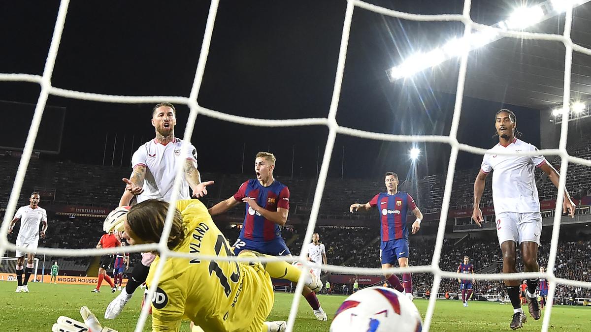 Sergio Ramos' own goal gifts Barcelona victory over Sevilla in La Liga